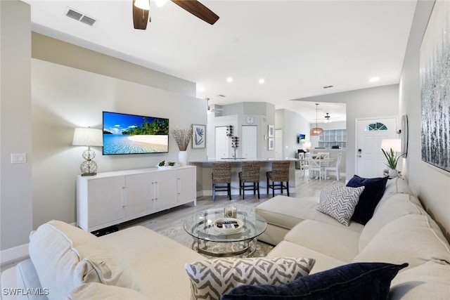 living room with ceiling fan and light wood-type flooring