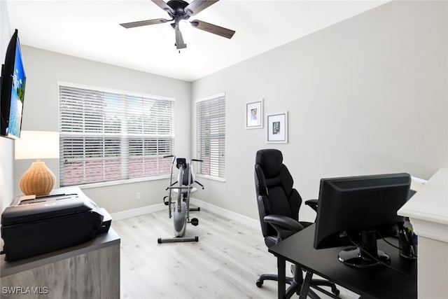 office area with light wood-type flooring and ceiling fan