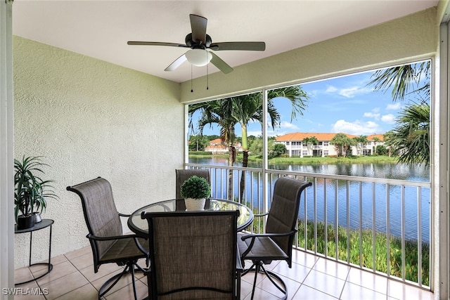 sunroom featuring a water view, a wealth of natural light, and ceiling fan