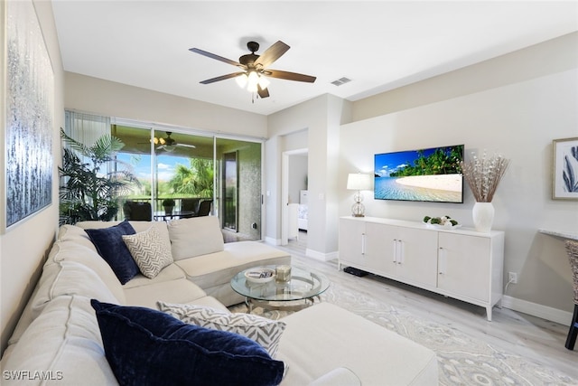 living room featuring ceiling fan and light hardwood / wood-style floors