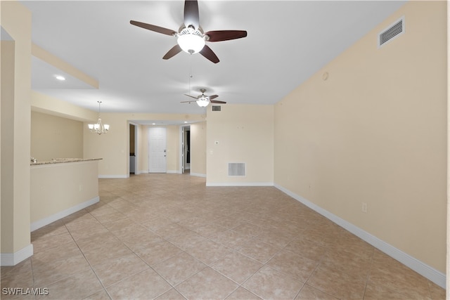 spare room with light tile patterned floors and ceiling fan with notable chandelier