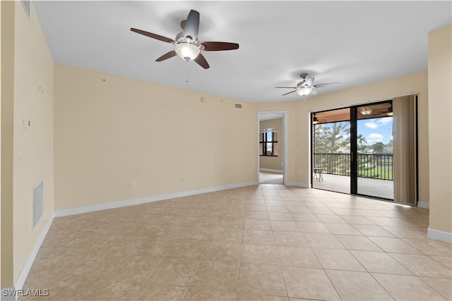 empty room with ceiling fan and light tile patterned floors