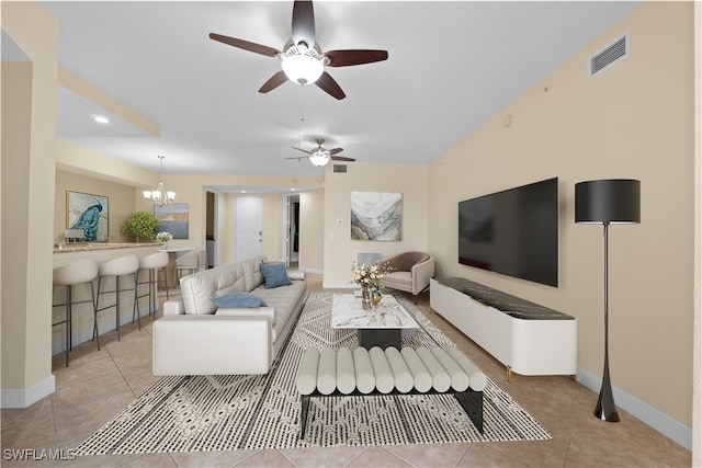 living room with ceiling fan with notable chandelier and light tile patterned floors