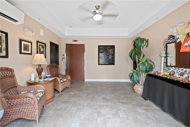 living area with a wall mounted air conditioner, elevator, ceiling fan, and a tray ceiling