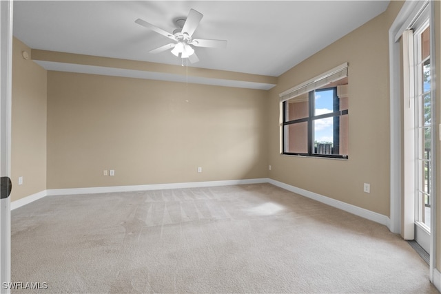 carpeted spare room with ceiling fan