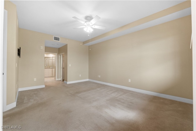 carpeted empty room featuring ceiling fan