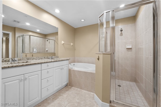 bathroom with tile patterned flooring, vanity, and independent shower and bath