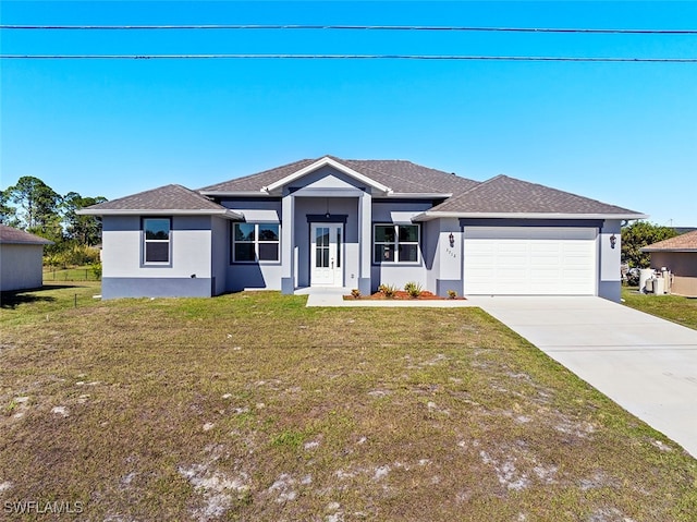 view of front of home featuring a garage and a front lawn