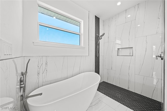 bathroom featuring tile walls and plus walk in shower