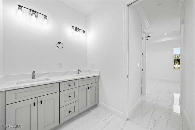 bathroom with crown molding and vanity