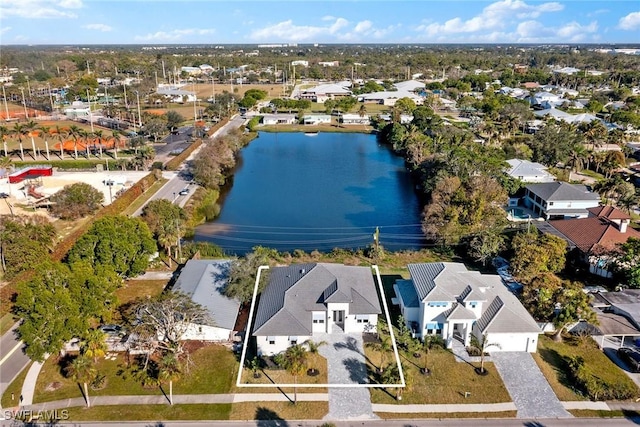 drone / aerial view featuring a water view and a residential view