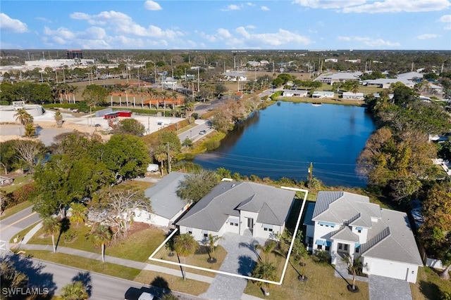 birds eye view of property with a water view and a residential view