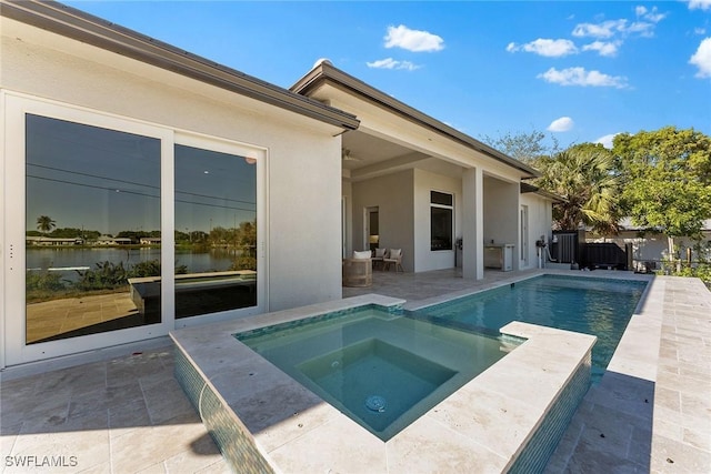 view of swimming pool featuring a patio area, a fenced in pool, and an in ground hot tub