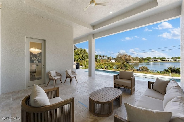 view of patio with an outdoor hangout area, a water view, a ceiling fan, and an outdoor pool