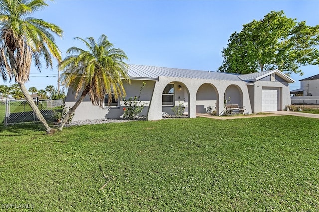 ranch-style house featuring a garage and a front yard