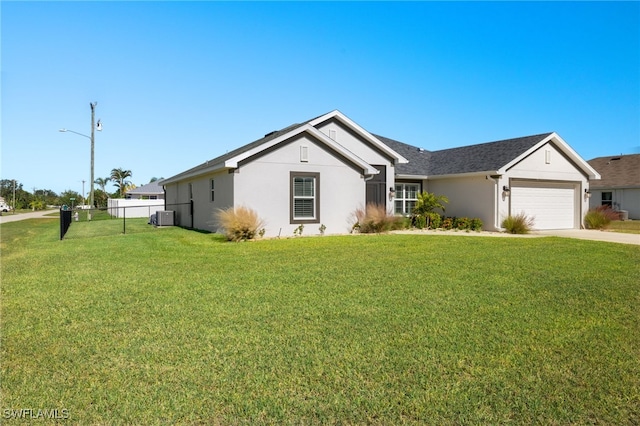 ranch-style home with a front yard, a garage, and central AC unit