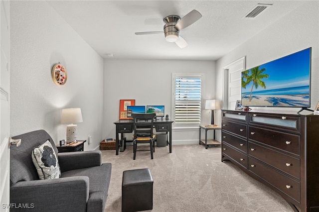 office featuring ceiling fan and light carpet