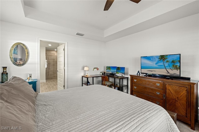 bedroom with light carpet, connected bathroom, and ceiling fan