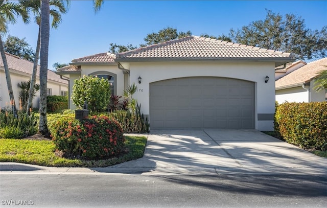 mediterranean / spanish-style home with a garage