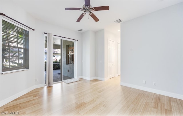 empty room with ceiling fan and light wood-type flooring