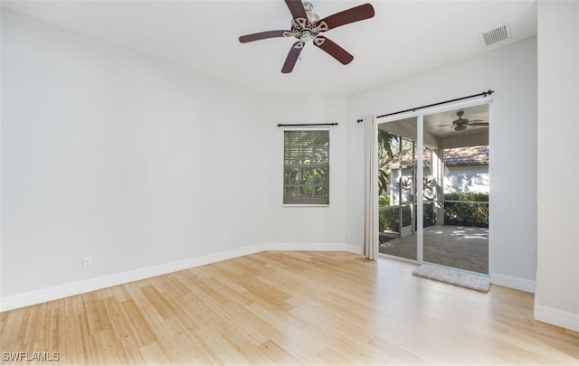 empty room with ceiling fan and light wood-type flooring