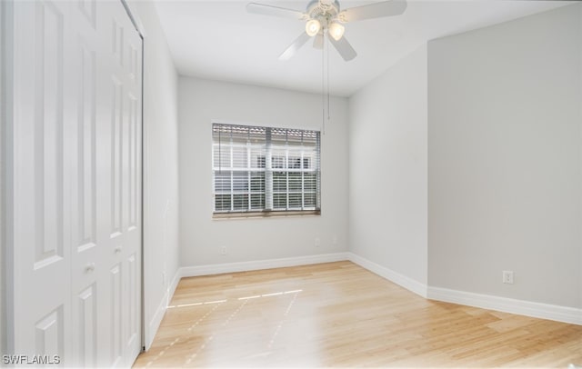 empty room with ceiling fan and light wood-type flooring