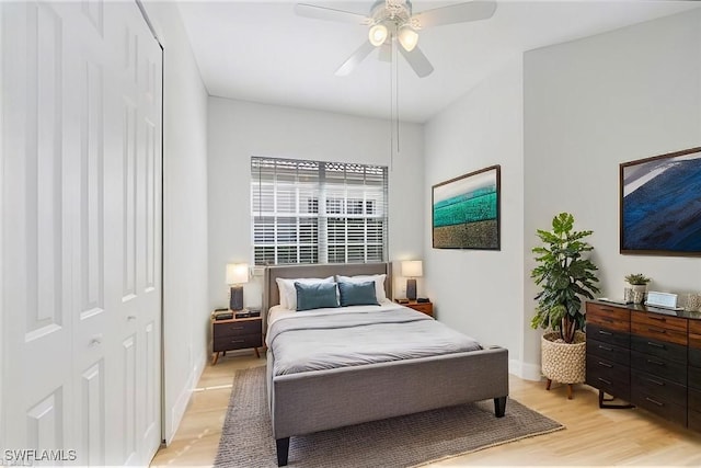 bedroom with ceiling fan, light wood-type flooring, and a closet