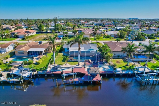 drone / aerial view with a water view and a residential view