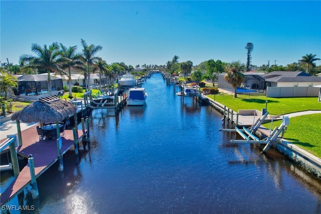 view of dock featuring a yard and a water view