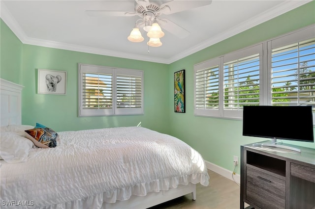 bedroom featuring multiple windows, ceiling fan, and ornamental molding