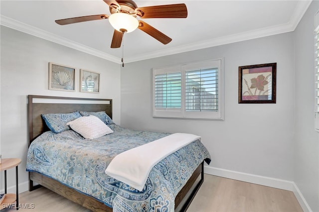 bedroom featuring baseboards, wood finished floors, crown molding, and ceiling fan