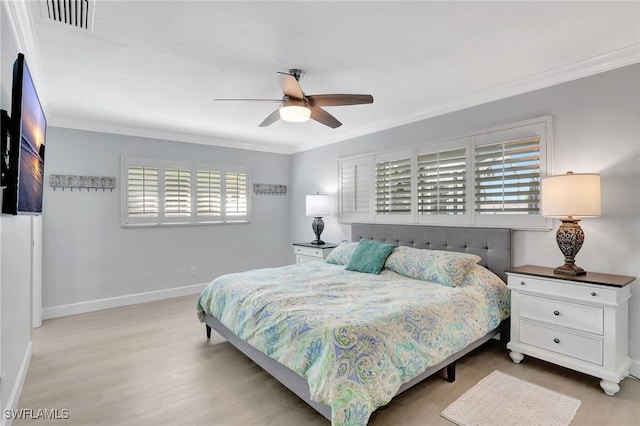 bedroom featuring ornamental molding, wood finished floors, baseboards, and ceiling fan