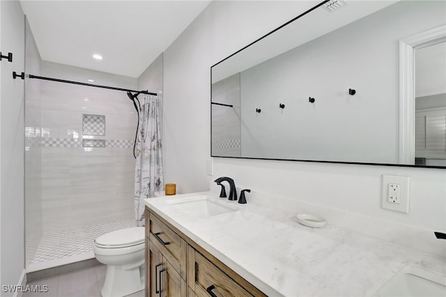 full bath with a tile shower, tile patterned floors, vanity, and toilet