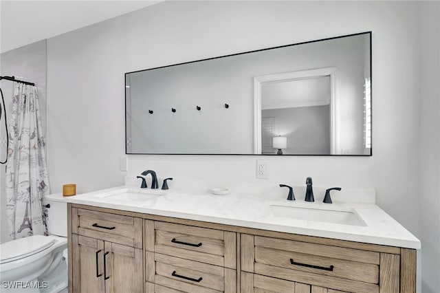 bathroom with double vanity, toilet, and curtained shower