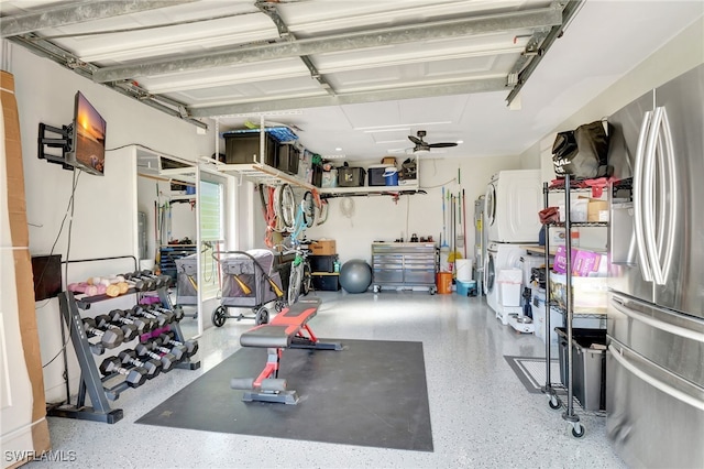 workout room with stacked washer and clothes dryer and a garage