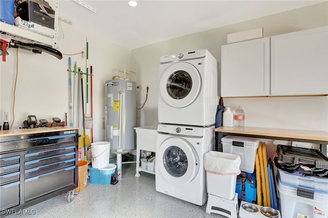 washroom featuring estacked washer and dryer, electric water heater, and recessed lighting