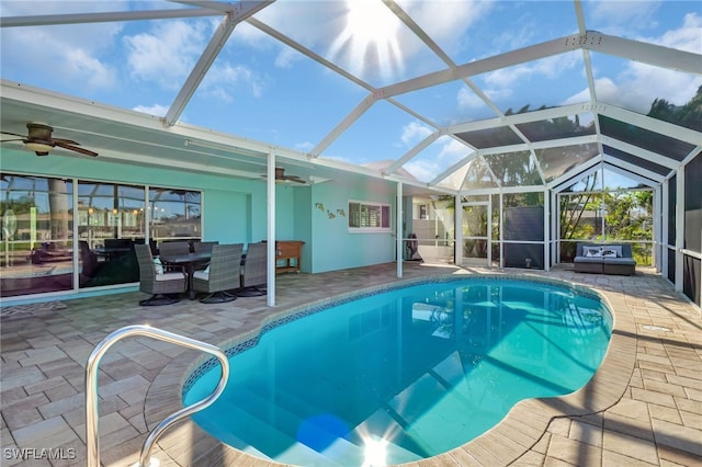outdoor pool with ceiling fan, a patio, a lanai, and outdoor dining space