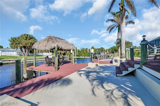 view of home's community featuring a dock, boat lift, and a water view