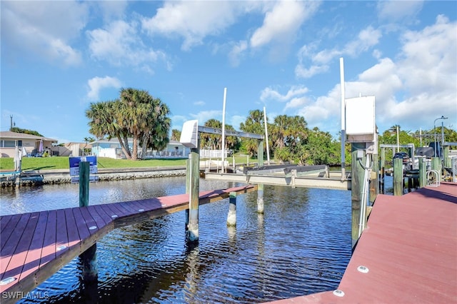 dock featuring boat lift and a water view