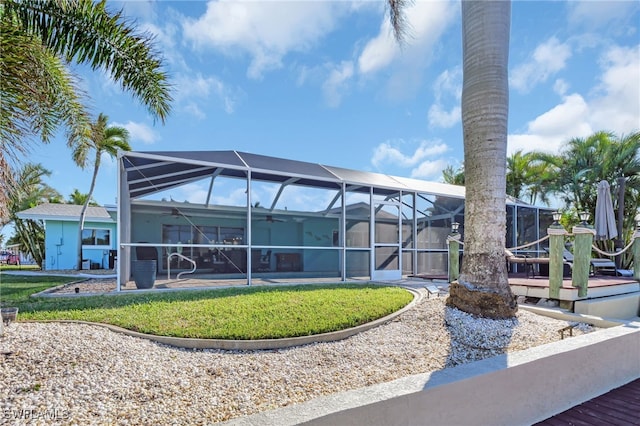 rear view of property featuring glass enclosure