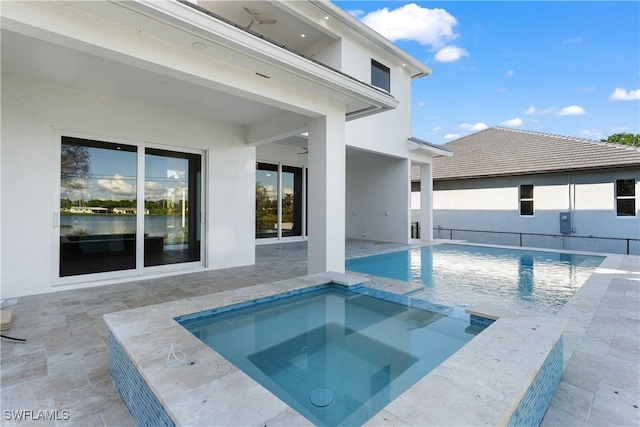 view of swimming pool with a patio, ceiling fan, and an in ground hot tub