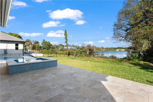 view of patio / terrace with an in ground hot tub and a water view