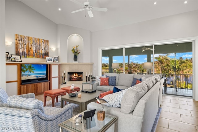 tiled living room featuring ceiling fan and lofted ceiling