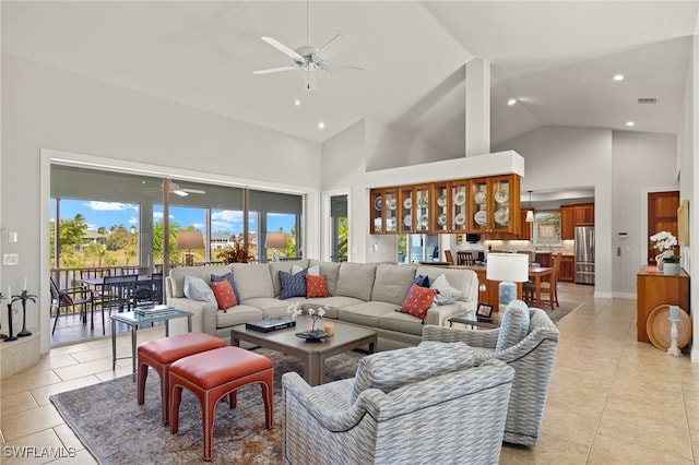 tiled living room with ceiling fan and high vaulted ceiling