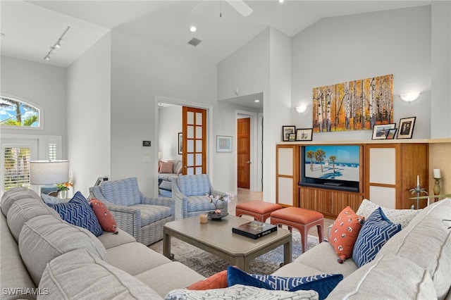 living room with rail lighting, high vaulted ceiling, and ceiling fan