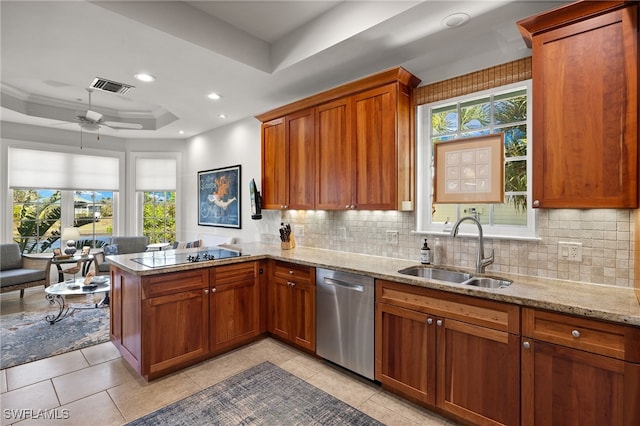 kitchen with dishwasher, sink, a raised ceiling, plenty of natural light, and black electric cooktop