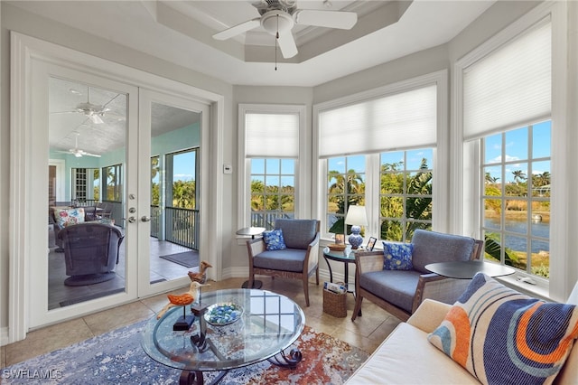 sunroom / solarium with a raised ceiling, a wealth of natural light, and french doors