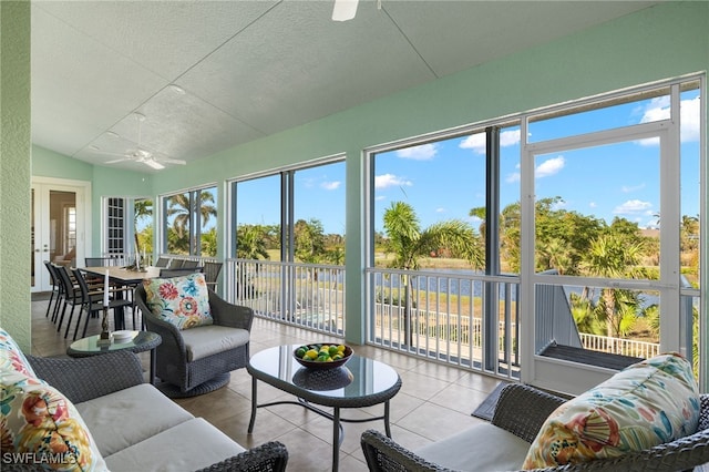 sunroom with ceiling fan and lofted ceiling