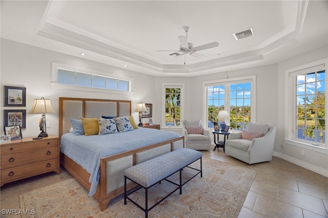 bedroom with light tile patterned floors, a raised ceiling, and ceiling fan