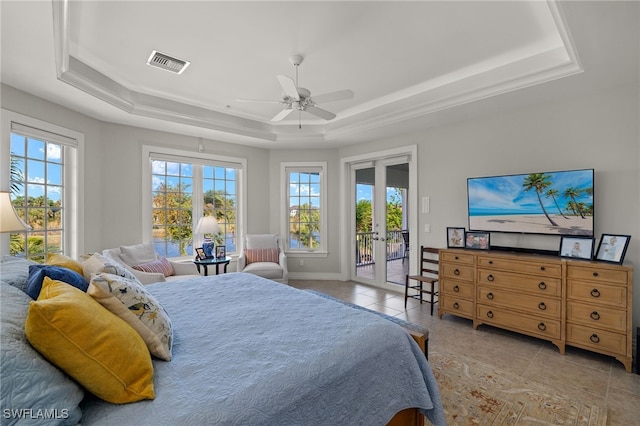 bedroom featuring french doors, access to outside, ceiling fan, and a tray ceiling